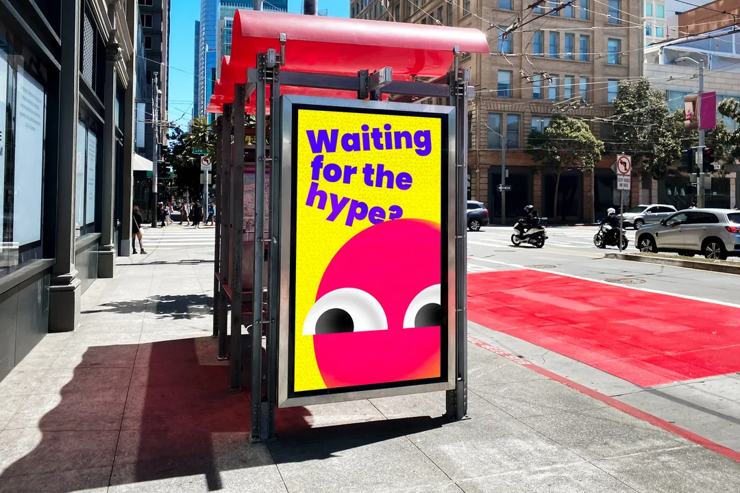 Bus stop on a city street with a POG poster: Waiting for the hype?