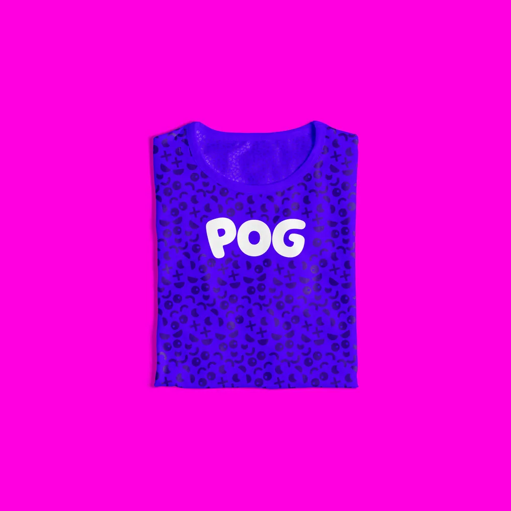 Folded violet tee with a pattern print and the POG wordmark on magenta