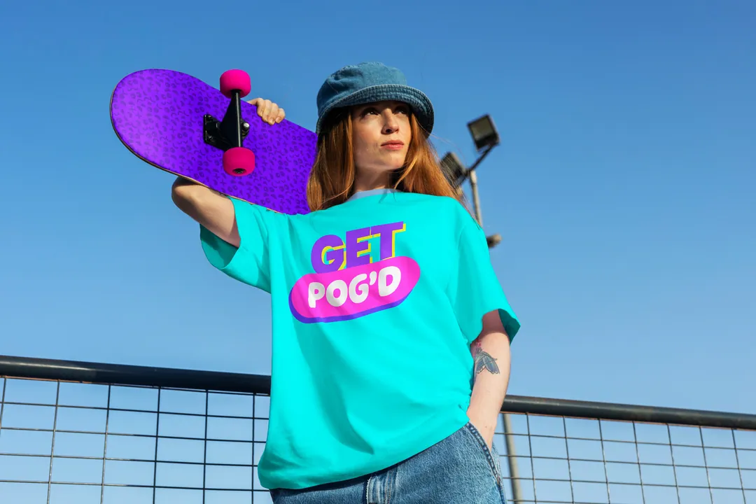 Skater in a turquoise Get POG'd tee holding a violet board