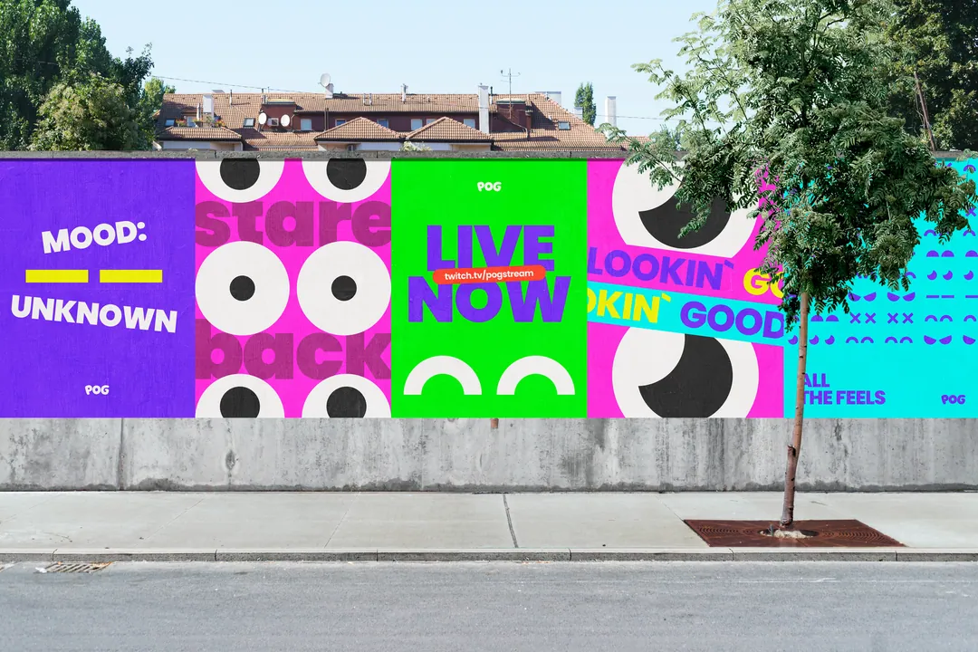 Wall of POG street posters in the full palette along a pavement