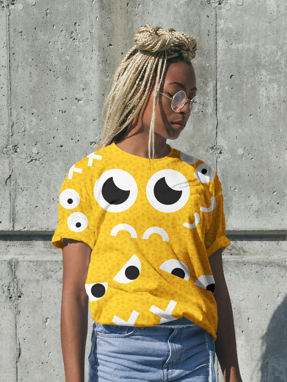 Model in a yellow tee with an all-over POG eye print