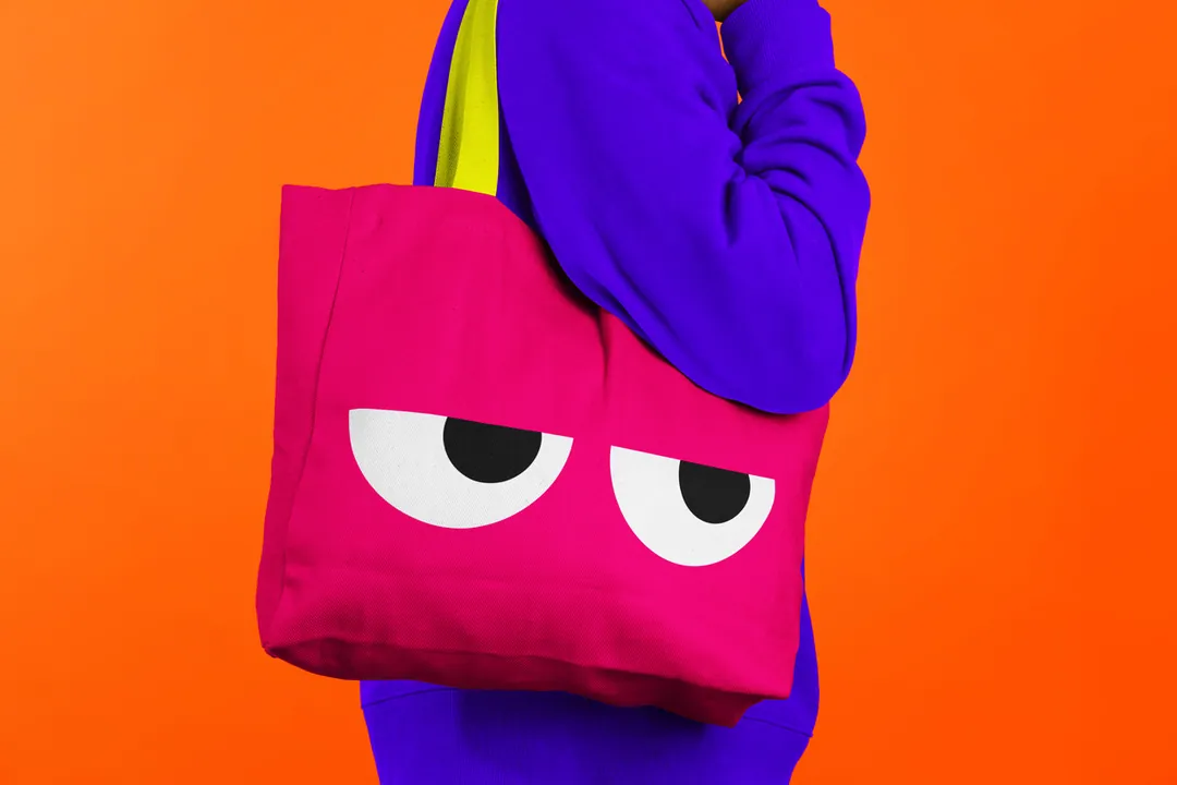 Pink tote bag with oversized POG eyes